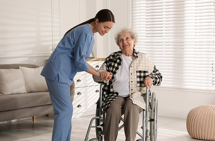 Caregiver in uniform smiling and serving the patient